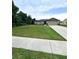 Charming single-story home boasts a well-manicured lawn, neutral exterior, and an attached two-car garage at 1115 Adirondack St, Deltona, FL 32725