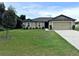 Inviting home featuring manicured lawn, neutral siding, clean lines, and an attached two-car garage at 1115 Adirondack St, Deltona, FL 32725