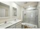 Modern bathroom featuring double sinks, a white vanity, and a glass shower at 1161 Kenway Ave, Deltona, FL 32738