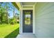 Elegant front door with decorative glass details and a modern black finish at 1161 Kenway Ave, Deltona, FL 32738