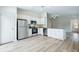 Well lit kitchen with stainless steel appliances, light wood flooring, and a view to the entryway at 1161 Kenway Ave, Deltona, FL 32738
