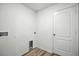 Clean laundry room featuring a utility sink hookup, dryer access, and a white door at 1161 Kenway Ave, Deltona, FL 32738