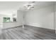 Bright living room with open floor plan, ceiling fan, and durable gray vinyl floors at 1161 Kenway Ave, Deltona, FL 32738