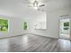 Spacious living room with large windows, open floor plan, and modern light gray vinyl floors at 1161 Kenway Ave, Deltona, FL 32738
