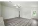 Cozy living room featuring an open floor plan, stylish gray flooring, and ample natural light at 1161 Kenway Ave, Deltona, FL 32738