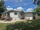 Backyard features a brick patio, sun loungers, and ample space at 1215 N Boston Ave, Deland, FL 32724