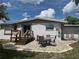 The backyard features a cozy brick patio perfect for outdoor dining and relaxation at 1215 N Boston Ave, Deland, FL 32724