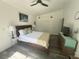 Bedroom featuring ceiling fan, wood floors, and beach themed decor at 1215 N Boston Ave, Deland, FL 32724