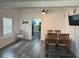Cozy dining room with a wooden table, view into the kitchen, and a TV mounted on the wall at 1215 N Boston Ave, Deland, FL 32724
