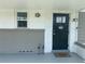 Welcoming front entrance featuring a decorative door, turtle and flamingo decor, and a welcome mat at 1215 N Boston Ave, Deland, FL 32724