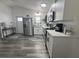 Bright and airy kitchen featuring stainless steel appliances, white cabinets, and modern fixtures at 1215 N Boston Ave, Deland, FL 32724