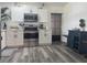 Updated kitchen showcasing stainless steel appliances, white cabinetry, and stylish countertops at 1215 N Boston Ave, Deland, FL 32724