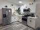 Modern kitchen featuring stainless steel appliances, white cabinets, and ample counter space at 1215 N Boston Ave, Deland, FL 32724