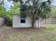 Exterior view of the backyard shed under a palm tree at 1215 N Boston Ave, Deland, FL 32724
