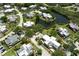 Aerial view showcasing the community, landscaping, and a tranquil pond at 122 Cedar Dunes Dr, New Smyrna Beach, FL 32169