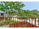 Balcony view overlooking a street with mature trees and landscaping at 122 Cedar Dunes Dr, New Smyrna Beach, FL 32169