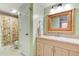 Bathroom featuring a single sink vanity with a rattan framed mirror and tub shower combo at 122 Cedar Dunes Dr, New Smyrna Beach, FL 32169