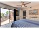 Bedroom with an outdoor balcony, tile floor, ceiling fan, nautical decor, and white dresser at 122 Cedar Dunes Dr, New Smyrna Beach, FL 32169