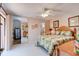 Bedroom with tile floor, mirrored closet, en suite bathroom, and sliding doors to a small outdoor deck at 122 Cedar Dunes Dr, New Smyrna Beach, FL 32169