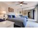 Bedroom featuring neutral walls, tile floor, mirrored closet, a ceiling fan and a large bed at 122 Cedar Dunes Dr, New Smyrna Beach, FL 32169