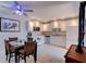 Bright kitchen featuring white cabinetry, modern appliances, and dining area with seating for four at 122 Cedar Dunes Dr, New Smyrna Beach, FL 32169
