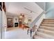 Open living room with tile floors, fireplace, and stairwell leading to the second floor at 122 Cedar Dunes Dr, New Smyrna Beach, FL 32169