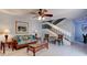 Cozy living room features tile flooring, a ceiling fan, and a staircase leading to the upper level at 122 Cedar Dunes Dr, New Smyrna Beach, FL 32169