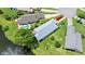 Aerial view of a well-manicured home on a large lot with a lake view at 123 Wood Ibis Ct, Daytona Beach, FL 32119