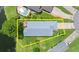 Aerial view of property showing roof, yard and proximity to lake, pool and other homes at 123 Wood Ibis Ct, Daytona Beach, FL 32119
