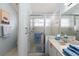 Bright bathroom featuring a clear glass door, sink, and blue accent towels at 123 Wood Ibis Ct, Daytona Beach, FL 32119