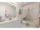 Well-lit bathroom featuring a tub and shower combination with elegant peach-colored curtain at 123 Wood Ibis Ct, Daytona Beach, FL 32119