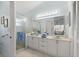 Spacious bathroom featuring a glass shower door, double sinks, and ample storage at 123 Wood Ibis Ct, Daytona Beach, FL 32119