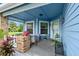Inviting front porch featuring a seating area surrounded by plants and flowers at 123 Wood Ibis Ct, Daytona Beach, FL 32119