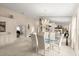 Open-concept living and dining area featuring a glass dining table, neutral decor, and ample natural light at 123 Wood Ibis Ct, Daytona Beach, FL 32119