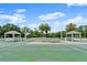 Well-maintained tennis court with shaded gazebos for players to rest between matches at 123 Wood Ibis Ct, Daytona Beach, FL 32119