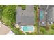 Stunning aerial view featuring a backyard pool and lush landscaping that complements the home's outdoor living space at 1261 Burning Tree Ln, Winter Park, FL 32792