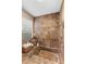 Tiled bath featuring a window with blinds, an ornate showerhead and a sunken tub at 1261 Burning Tree Ln, Winter Park, FL 32792