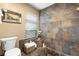 Tiled bath featuring a window with blinds, a toilet and a sunken tub at 1261 Burning Tree Ln, Winter Park, FL 32792