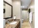 Well-lit bathroom featuring a vanity with granite countertops and updated fixtures at 1261 Burning Tree Ln, Winter Park, FL 32792