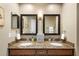 Bathroom featuring a double vanity with granite countertops and modern mirrors at 1261 Burning Tree Ln, Winter Park, FL 32792