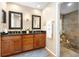 Bathroom with a double sink vanity, dark wood cabinets and a view into the soaking tub area at 1261 Burning Tree Ln, Winter Park, FL 32792