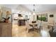 Stylish dining area adjacent to the kitchen with a round table, pendant lighting, and a view of lush outdoors at 1261 Burning Tree Ln, Winter Park, FL 32792