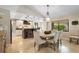 Bright dining area featuring a round table, upholstered chairs, and a view of the kitchen island at 1261 Burning Tree Ln, Winter Park, FL 32792