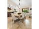 Dining area with a round table, upholstered chairs, and natural light from the window at 1261 Burning Tree Ln, Winter Park, FL 32792