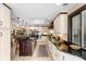Elegant kitchen featuring a dark island, sleek appliances, and seamless connection to the dining area at 1261 Burning Tree Ln, Winter Park, FL 32792