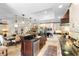 Spacious kitchen features a center island, granite countertops and stainless steel appliances with a dining area at 1261 Burning Tree Ln, Winter Park, FL 32792
