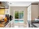 Bright kitchen with granite counters and sliding doors leading to the pool area at 1261 Burning Tree Ln, Winter Park, FL 32792