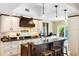 Open kitchen with granite counters, bar seating, and pendant lighting at 1261 Burning Tree Ln, Winter Park, FL 32792