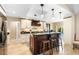 Modern kitchen featuring a center island with bar seating, granite countertops, and custom cabinetry at 1261 Burning Tree Ln, Winter Park, FL 32792