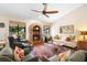 Cozy living room features a brick fireplace, ceiling fan and neutral color palette at 1261 Burning Tree Ln, Winter Park, FL 32792